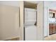 Stacked white washer and dryer inside a closet for convenient laundry access at 4952 Tangerine Ave # 4952, Winter Park, FL 32792