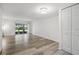 Bright living room features updated flooring and a sliding glass door at 4952 Tangerine Ave # 4952, Winter Park, FL 32792