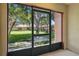View from the enclosed patio featuring well-manicured lawns and mature trees at 4952 Tangerine Ave # 4952, Winter Park, FL 32792
