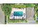 Aerial shot of a community pool surrounded by palms, hedges, lounge chairs and shade trees at 4952 Tangerine Ave # 4952, Winter Park, FL 32792