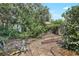 The backyard has mature trees, brick pavers, and a wooden fence at 5382 Sw 84Th Pl, Ocala, FL 34476