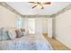 Well-lit bedroom featuring ceiling fan, plush carpeting and a view to the ensuite bathroom at 5382 Sw 84Th Pl, Ocala, FL 34476