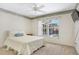 Comfortable bedroom featuring ceiling fan and a window overlooking the pool area at 5382 Sw 84Th Pl, Ocala, FL 34476