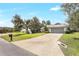 Well-maintained home featuring mature trees, a long driveway and verdant landscaping at 5382 Sw 84Th Pl, Ocala, FL 34476