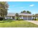 Charming single-story home with a well-manicured lawn, mature landscaping and a two-car garage at 5382 Sw 84Th Pl, Ocala, FL 34476
