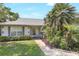 Inviting home entrance features a landscaped walkway and charming seating at 5382 Sw 84Th Pl, Ocala, FL 34476