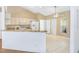 Open kitchen features granite countertops, white appliances, and tile flooring at 5382 Sw 84Th Pl, Ocala, FL 34476