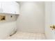 The bright laundry room has tile floor and cabinets at 5382 Sw 84Th Pl, Ocala, FL 34476