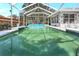 The large covered pool is surrounded by well-maintained landscaping and patio furniture at 5382 Sw 84Th Pl, Ocala, FL 34476