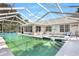 The covered pool has steps to an integrated spa at 5382 Sw 84Th Pl, Ocala, FL 34476
