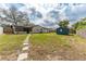 Large backyard with walkway to the back of the home and shed at 540 Diane Cir, Casselberry, FL 32707