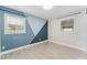 Modern bedroom with unique painted walls, tiled floor, and windows for natural light at 540 Diane Cir, Casselberry, FL 32707