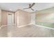 Spacious bedroom featuring modern flooring, ceiling fan, and access to an ensuite bathroom at 540 Diane Cir, Casselberry, FL 32707