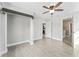 Bedroom with open closet concept, ceiling fan, access to ensuite, and light colored flooring at 540 Diane Cir, Casselberry, FL 32707