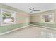 Bright bedroom with a ceiling fan, stylish floors, and two windows providing ample natural light at 540 Diane Cir, Casselberry, FL 32707