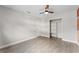 Bedroom with hardwood floors, ceiling fan, open closet, and access to ensuite bathroom at 540 Diane Cir, Casselberry, FL 32707