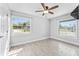 Bedroom with hardwood floors, a ceiling fan, and two windows offering natural light and views at 540 Diane Cir, Casselberry, FL 32707