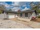 Charming single-story home with a manicured lawn, flower bed, and an attached one-car garage at 540 Diane Cir, Casselberry, FL 32707