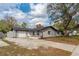Charming one-story home with a well-manicured lawn, front flower bed, and an attached one-car garage at 540 Diane Cir, Casselberry, FL 32707