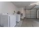 Attached garage includes washer and dryer with patterned tile flooring at 540 Diane Cir, Casselberry, FL 32707