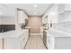 Bright and modern kitchen featuring white cabinetry, stainless steel appliances, and sleek countertops at 540 Diane Cir, Casselberry, FL 32707