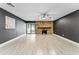 Inviting living room with a striking stone fireplace, tile flooring, and sliding glass doors at 540 Diane Cir, Casselberry, FL 32707