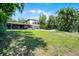 Expansive backyard features lush greenery, patio and plenty of space for outdoor activities and enjoyment at 5671 Cypress Gardens Rd, Winter Haven, FL 33884