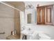 Bathroom with a tiled shower, updated vanity, and stylish vanity lighting at 5671 Cypress Gardens Rd, Winter Haven, FL 33884