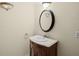 Traditional half bathroom with ornate vanity, stylish lighting, and decorative mirror at 5671 Cypress Gardens Rd, Winter Haven, FL 33884