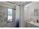 Updated bathroom with a marble-tiled shower, a window and a modern vanity at 5671 Cypress Gardens Rd, Winter Haven, FL 33884