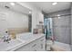 Bright bathroom with tub and shower, marble countertop, white vanity, and tile flooring at 5671 Cypress Gardens Rd, Winter Haven, FL 33884