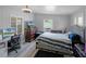 Spacious bedroom with wood floors, a ceiling fan, and lots of natural light at 5671 Cypress Gardens Rd, Winter Haven, FL 33884