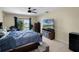 Bedroom features sliding glass doors to deck, ceiling fan, and tv at 5671 Cypress Gardens Rd, Winter Haven, FL 33884