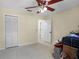 Bedroom with tile flooring, ceiling fan, closet and multiple access doors at 5671 Cypress Gardens Rd, Winter Haven, FL 33884
