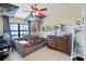 Bright bedroom with a neutral color palette, large window, and a ceiling fan at 5671 Cypress Gardens Rd, Winter Haven, FL 33884