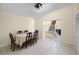 Well-lit dining room with tiled floors and an adjacent staircase at 5671 Cypress Gardens Rd, Winter Haven, FL 33884