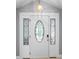 Elegant front door with decorative glass, complemented by sidelights and a modern locking system at 5671 Cypress Gardens Rd, Winter Haven, FL 33884
