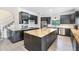 Open kitchen with kitchen island, dark cabinetry, stainless appliances, and wood countertops at 5671 Cypress Gardens Rd, Winter Haven, FL 33884