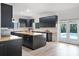 Open kitchen with wood countertops, dark cabinets, stainless steel appliances, and access to the outdoor pool at 5671 Cypress Gardens Rd, Winter Haven, FL 33884