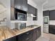 Kitchen area features stainless appliances, dark cabinets, and wood counters at 5671 Cypress Gardens Rd, Winter Haven, FL 33884