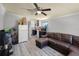 Cozy living room with an open layout, featuring a kitchen, and a comfortable brown leather sofa at 5671 Cypress Gardens Rd, Winter Haven, FL 33884