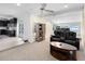 Spacious living room featuring black leather seating and adjacent kitchen area at 5671 Cypress Gardens Rd, Winter Haven, FL 33884