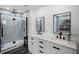 Contemporary bathroom featuring double sink vanity, modern fixtures, glass-enclosed shower, and updated design at 5671 Cypress Gardens Rd, Winter Haven, FL 33884