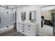 Modern bathroom with double sinks, glass enclosed shower, modern fixtures, and stylish vanity with white cabinets at 5671 Cypress Gardens Rd, Winter Haven, FL 33884