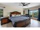 Bright main bedroom with tile floors, fan, king bed and sliding doors to the balcony with water views at 5671 Cypress Gardens Rd, Winter Haven, FL 33884