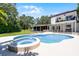 Backyard in-ground pool and spa with view of the home's exterior elevation at 5671 Cypress Gardens Rd, Winter Haven, FL 33884