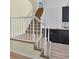 Carpeted staircase with white railing and adjacent kitchen area at 5671 Cypress Gardens Rd, Winter Haven, FL 33884