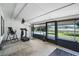 Screened-in sunroom with exercise equipment offers scenic views of the pool and waterfront at 5671 Cypress Gardens Rd, Winter Haven, FL 33884