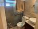 A clean bathroom featuring a glass door shower with decorative pebble floor and modern fixtures at 625 E Jackson Ave, Mount Dora, FL 32757