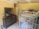 A room with a set of bunk beds, a wooden dresser, and a mirror at 625 E Jackson Ave, Mount Dora, FL 32757